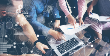 Group of professionals  gathered around laptop
