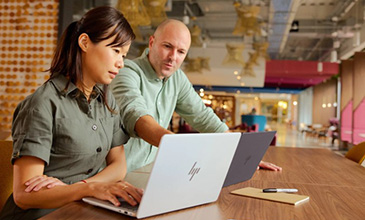 two people looking at screen of labtop